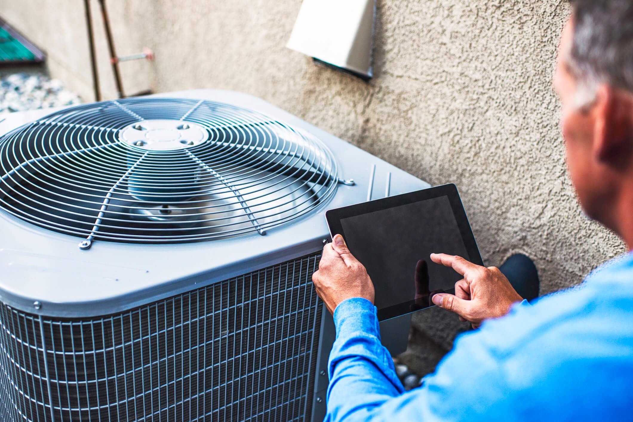 man troubleshooting air conditioner